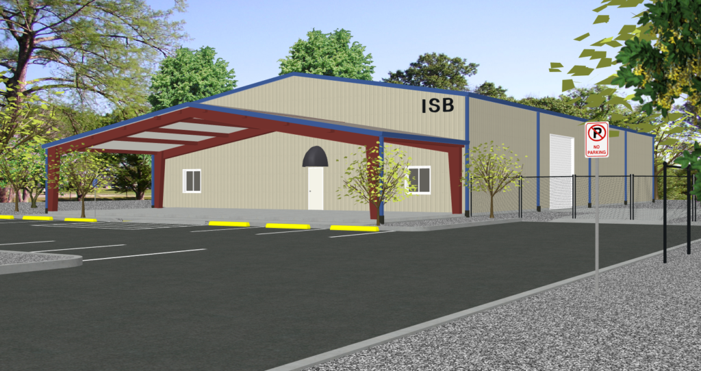 A large pre-engineered metal building featuring an open-wall, red iron steel endwall addition extension with a matching roof, providing covered outdoor storage for service vehicles and heavy machinery on a concrete pad.